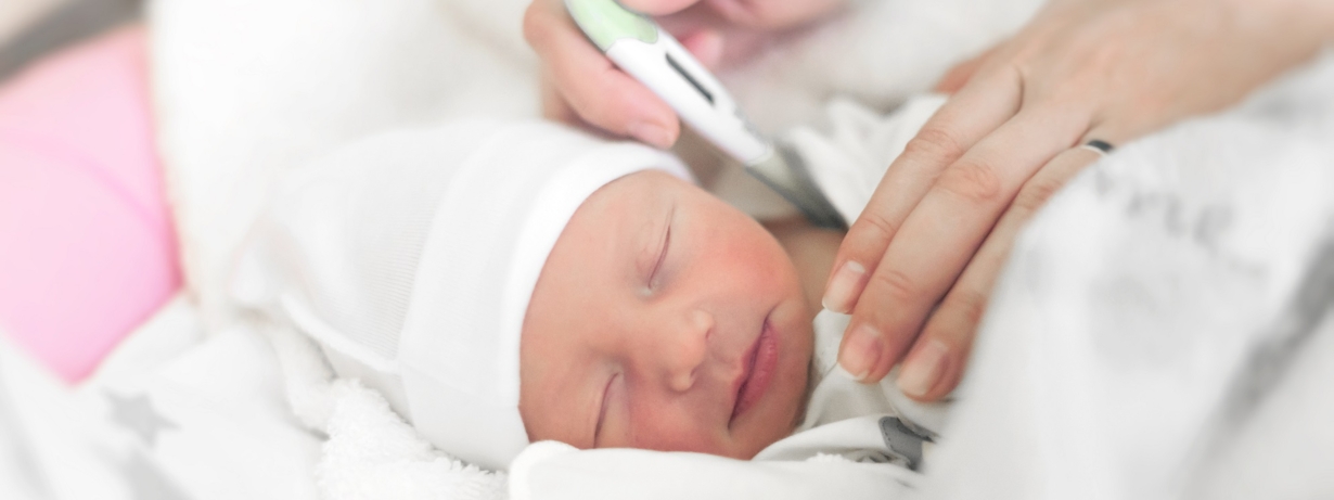 Newborn S Temperature And How To Keep It Normal   2515 A Woman Taking A Baby's Temperature 